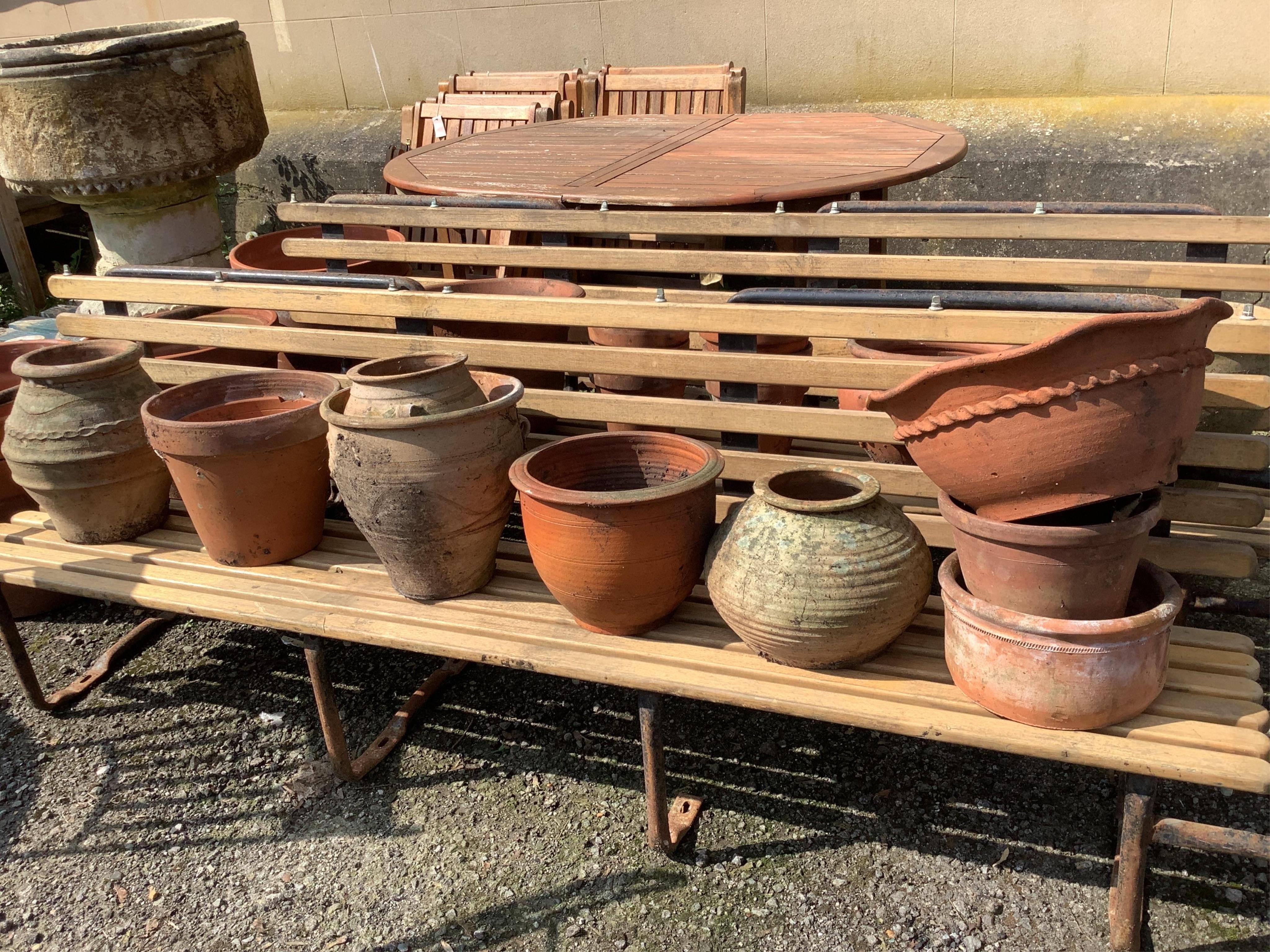 Twenty-one assorted terracotta garden planters, largest diameter 38cm, height 28cm